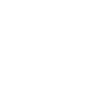 A person stands next to another person in a wheelchair, showing assistance or companionship.